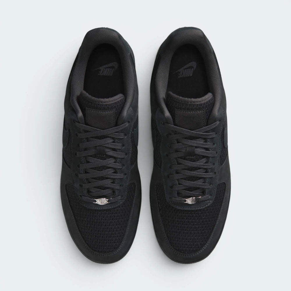 Focuses on the locked-in traditional lacing layout, displaying the perfect symmetry of the canvas tongue, the matching anthracite laces, and the neat stitching lines tracking down the textured canvas toe box area.