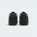 Focuses on the contoured shape of the padded low-cut collar, highlighting the embroidered Nike Air logo on the leather heel tab sitting squarely above the clean midsole line.