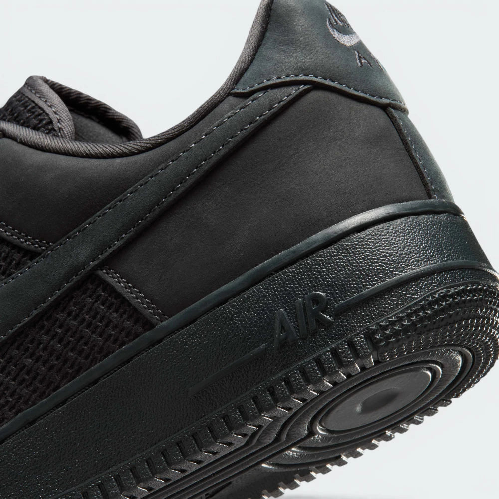 Highlights the "unreal" clean finish where the thick, classic AF1 midsole carrier securely bonds to the premium leather and canvas upper framework.