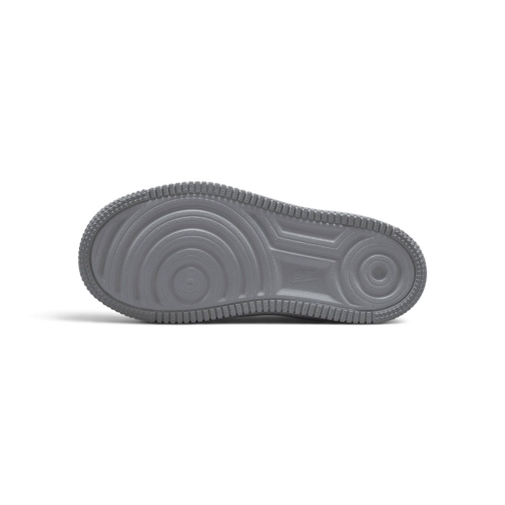 Focusing on the durable full-length rubber outsole featuring classic concentric pivot-circle traction rings, star-textured toe bumpers, and forefoot flex grooves, showcasing the grip matrix engineered for a successful tackle of playground tarmac, concrete, and indoor floors.
