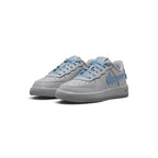 Showcasing the "unreal" clean lines, smooth wolf grey leather base, and high-contrast work blue Swoosh pop from a 45-degree perspective.