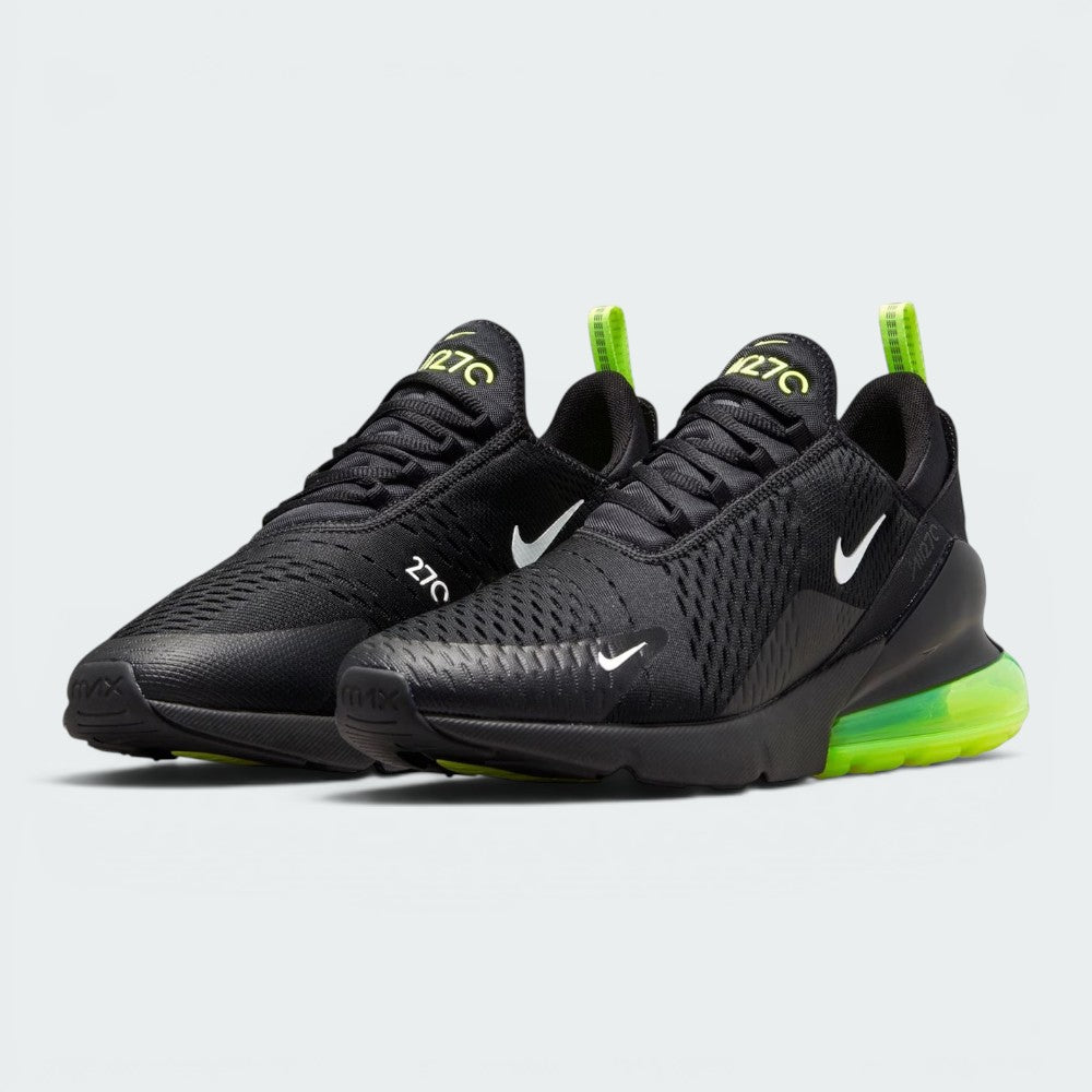 Emphasising the aggressive, athletic stance of the trainers, highlighting the contrast between the stealthy black mesh uppers and the popping Volt heel units and tongue logos.