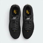 Focuses on the locked-in traditional lacing layout, displaying the perfect symmetry of the black textile tongue, the gold-accented logo patch, and the tightly woven mesh guarding the front toe box area.