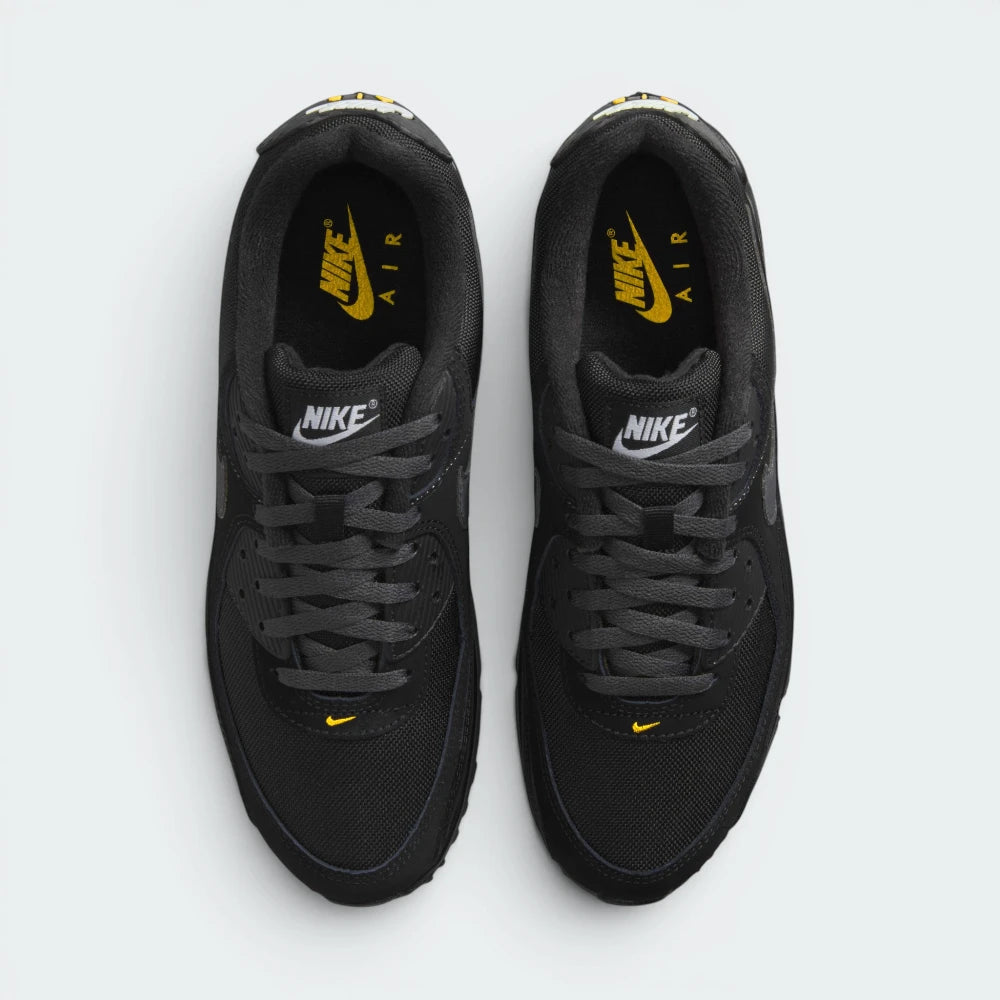 Focuses on the locked-in traditional lacing layout, displaying the perfect symmetry of the black textile tongue, the gold-accented logo patch, and the tightly woven mesh guarding the front toe box area.