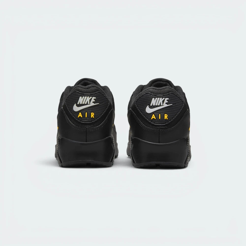 Focuses on the contoured shape of the rear spine, highlighting the ribbed TPU heel patch embedded with classic Nike Air block text branding.