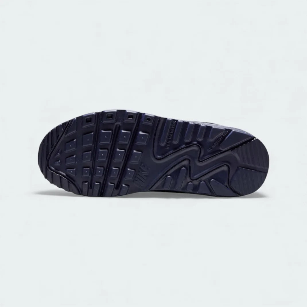 View of the outsole of the Nike Air Max 90 Leather Juniors' blue trainers, showing the durable rubber waffle tread pattern.