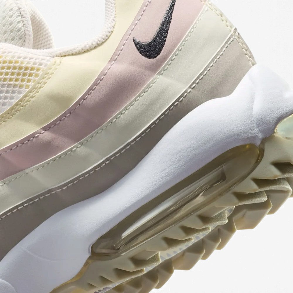 Macro view of the lateral heel transition, highlighting the cellular texture of the visible Max Air window and the aggressive profile of the sticky rubber turf lugs.