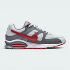Highlights the clean, layered side panels of the shoe, displaying the contrast between the Pure Platinum mesh base, Cool Grey synthetic overlays, and the vibrant Gym Red leather Swoosh tracking towards the rear. It also showcases the visible Gym Red Air Max unit embedded in the heel of the white midsole.