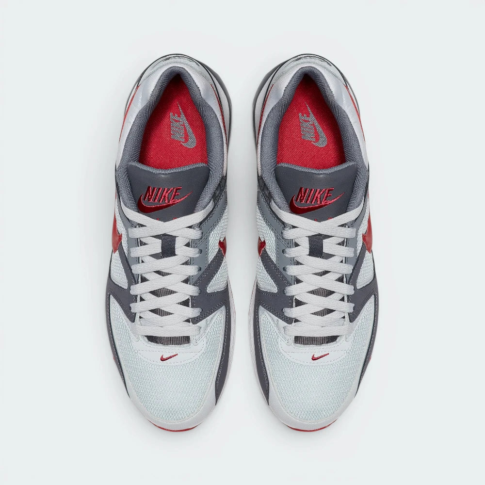 Displays the symmetrical layout of both shoes from above, emphasising the clean grey lace tracks, the embroidered red Nike branding on the grey mesh tongues, and the vibrant Gym Red insoles nestled inside the padded collar.