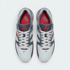 Displays the symmetrical layout of both shoes from above, emphasising the clean grey lace tracks, the embroidered red Nike branding on the grey mesh tongues, and the vibrant Gym Red insoles nestled inside the padded collar.