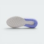 Displays the multi-directional traction grid of the sole, featuring a white rubber forefoot and midfoot zone interlocked with a translucent purple curved heel rim stamped with a clean white Nike Swoosh logo.