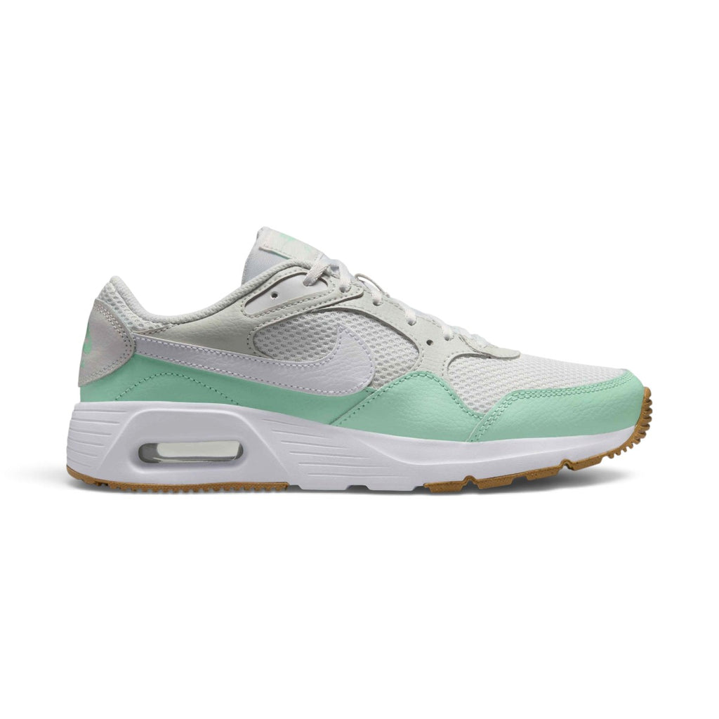 Studio lateral shot of the Nike Women's Air Max SC in Platinum Tint and Mint Foam, highlighting the mixed leather, textile and mesh upper, white Swoosh, visible Max Air window in the foam midsole, and gum light brown rubber outsole.