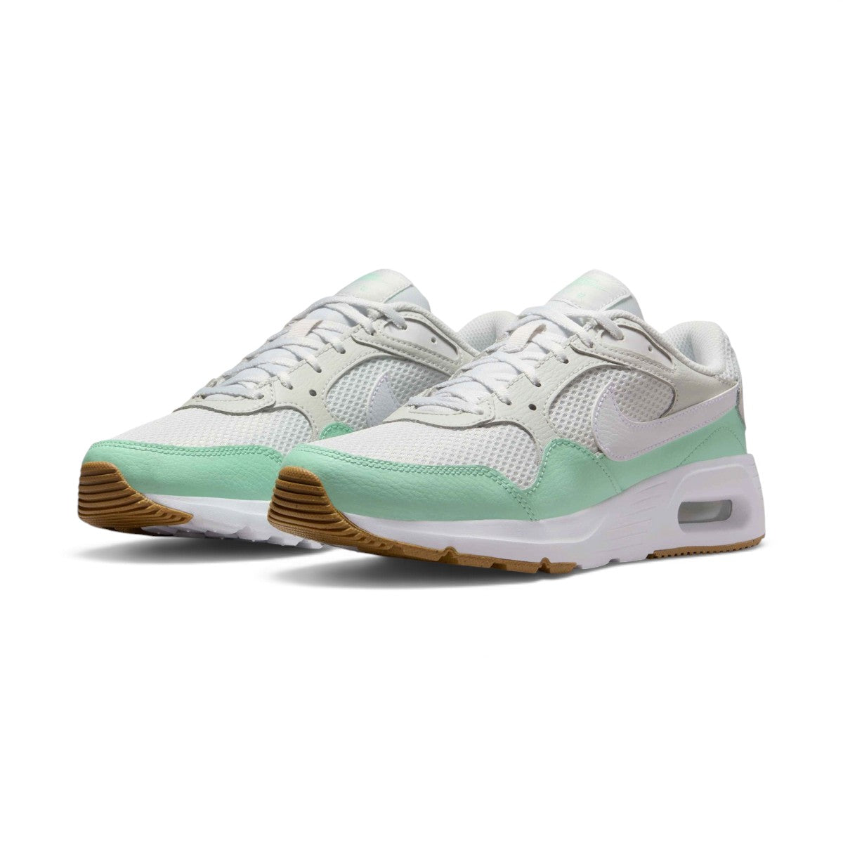Angled front-three-quarter perspective capturing the layered mesh toe box, mint mudguard accent, and clean profile of the lifestyle trainers.
