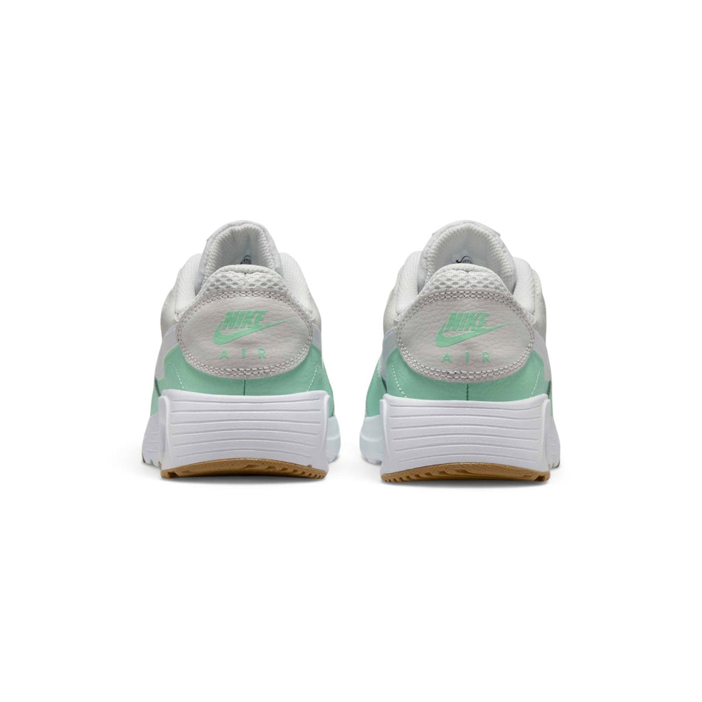 Rear-facing perspective focusing on the textured leather heel panel featuring mint Nike Air branding, stacked foam midsole, and the base of the gum outsole.