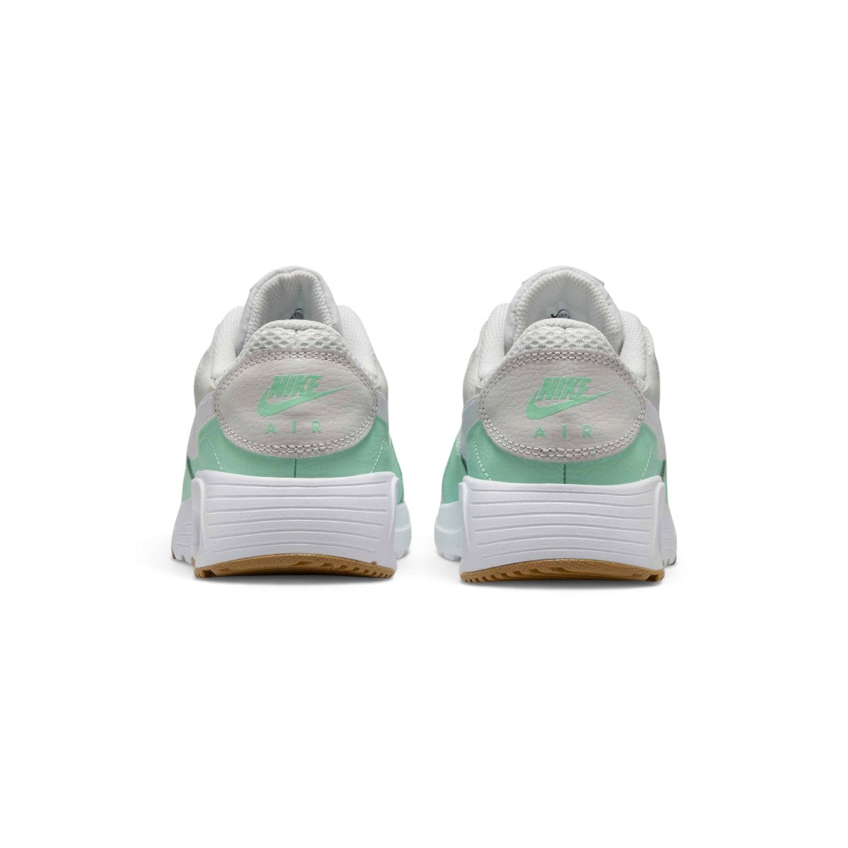 Rear-facing perspective focusing on the textured leather heel panel featuring mint Nike Air branding, stacked foam midsole, and the base of the gum outsole.