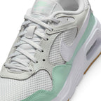 Macro focus on the breathable mesh texture, synthetic eyestays, and matching white flat athletic laces.
