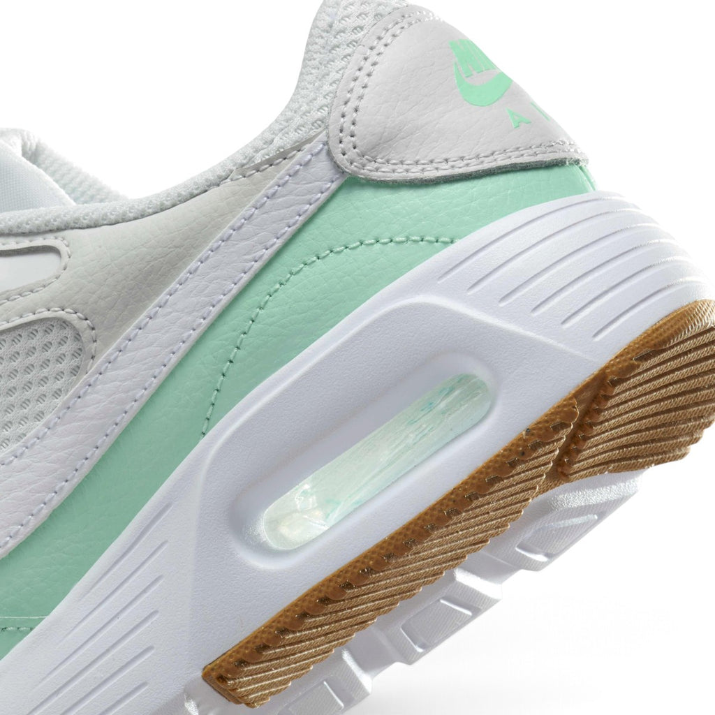 Detailed close-up angle capturing the transparent Max Air cushioning unit housed within the clean white foam midsole sidewall.