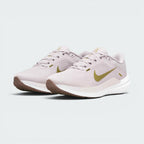 Emphasising the low-cut, athletic running stance of the trainers and the delicate colour harmony of the Platinum Violet uppers sitting cleanly above the white midsoles and brown outsoles.