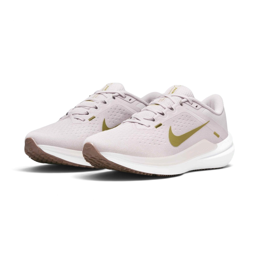 Emphasising the low-cut, athletic running stance of the trainers and the delicate colour harmony of the Platinum Violet uppers sitting cleanly above the white midsoles and brown outsoles.