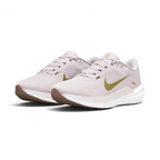Emphasising the low-cut, athletic running stance of the trainers and the delicate colour harmony of the Platinum Violet uppers sitting cleanly above the white midsoles and brown outsoles.