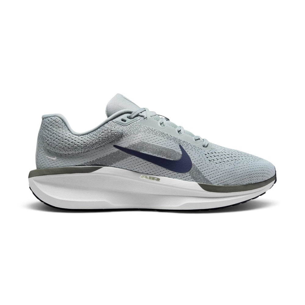 Highlights the lateral silhouette showing the Light Pumice engineered mesh upper, prominent Obsidian navy Nike Swoosh, olive-grey Cushlon rim stamped with "AIR", thick white foam midsole, and black rubber outsole. Main image