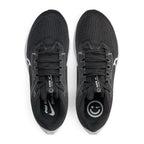 Overhead view looking down at the laced black running shoes, displaying the flat black laces, branded tongue tag featuring "nike running just do it", and the playful smiley graphic printed on the custom insoles.