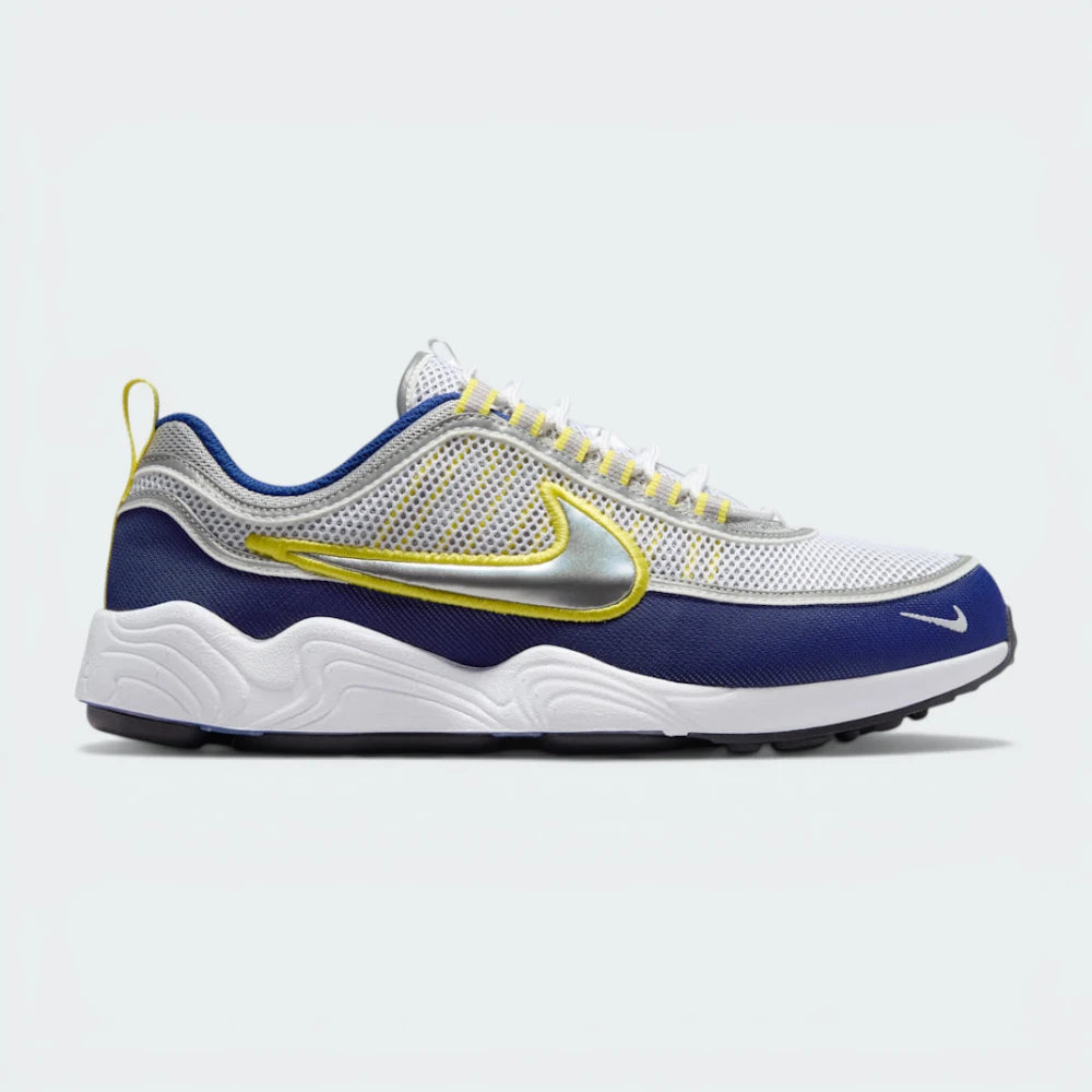 Side Profile Image: The White and Deep Royal Blue Spiridon, highlighting the wavy mudguard and the shimmering Metallic Silver Swoosh.