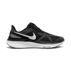 Side profile of the Nike Air Zoom Structure 25 Men's Road Running Trainer in Black, White, and Iron Grey showing engineered mesh upper, white foam midsole, Zoom Air branding, and white side Swoosh.
