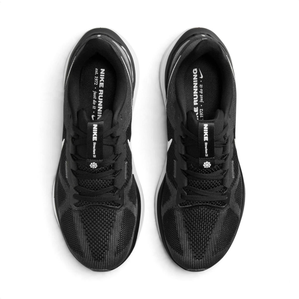Overhead view of both running shoes showing the breathable black mesh forefeet, central lacing systems, and branded insoles featuring "NIKE RUNNING est. 1972".