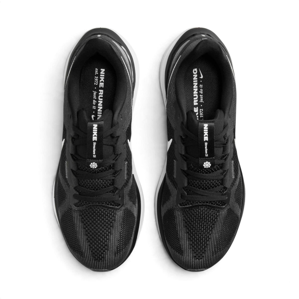 Overhead view of both running shoes showing the breathable black mesh forefeet, central lacing systems, and branded insoles featuring "NIKE RUNNING est. 1972".