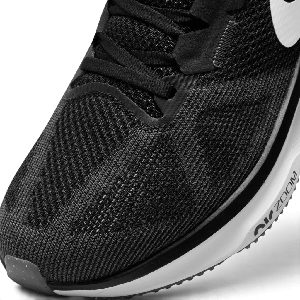 Macro focus on the forefoot and eyestay, detailing the fine mesh weave, black laces, and reinforced structure stitching.