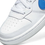 Details the micro-precision of the forefoot, displaying the clean white leather toe box with ventilation perforations, double-stitched toe overlay, crisp white flat laces, and the front tip of the Photo Blue Swoosh.