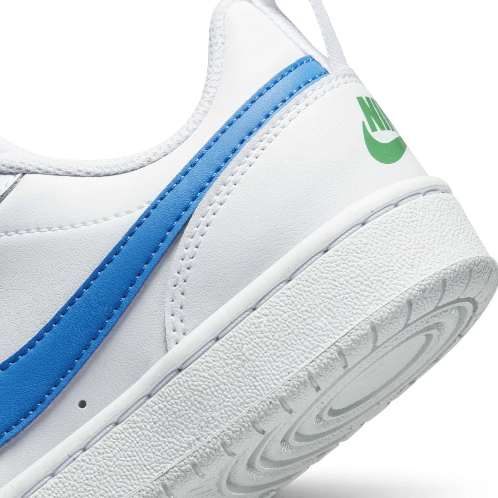 Highlights the heel section showing the stitched white cupsole sidewall, deep concentric traction circles on the rubber outsole, vibrant Photo Blue leather Swoosh tail, and green printed "NIKE" heel text with swoosh.