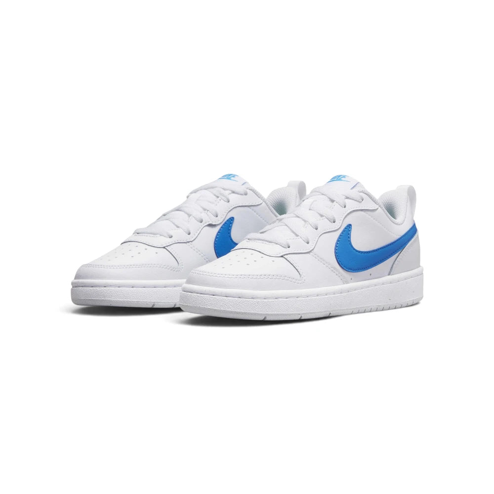 Emphasising the low-profile hardwood stance of the trainers and the sharp, clean contrast between the pristine white leather base and vibrant blue and green accent detailing.