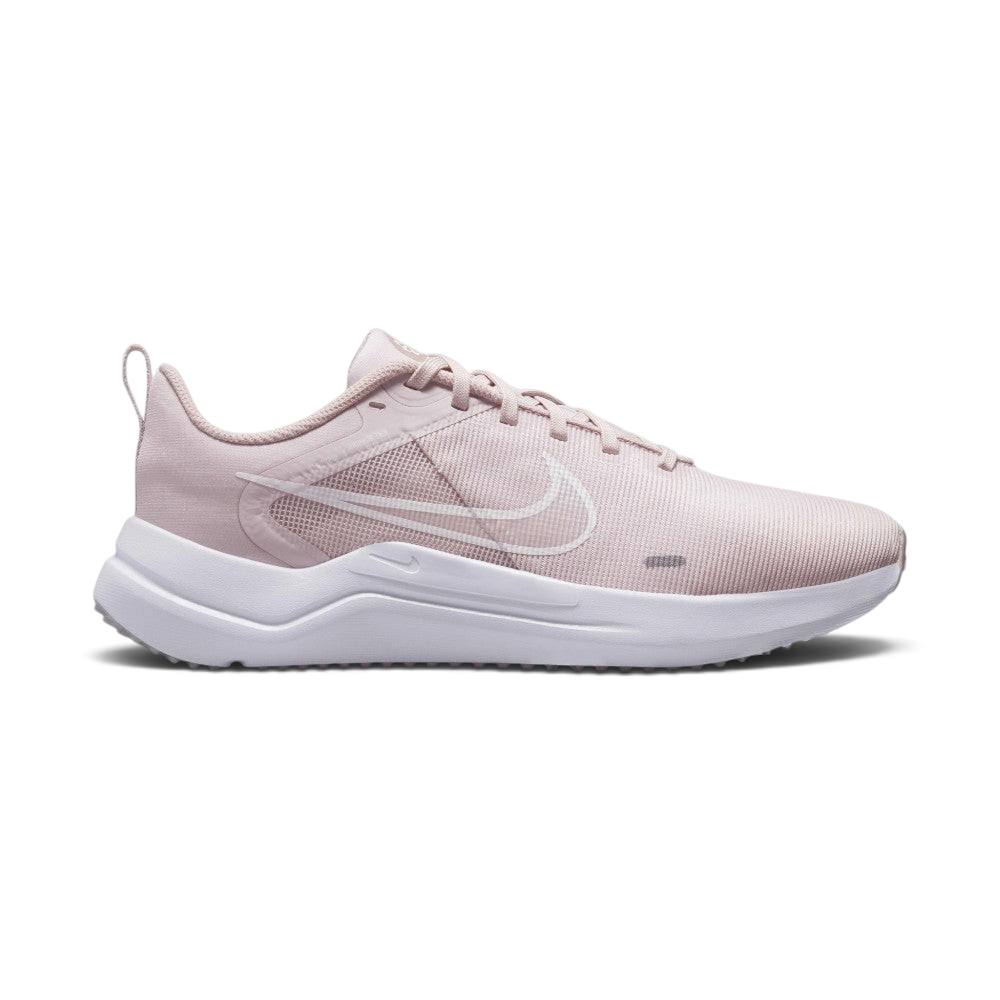 Highlights the lateral profile showing the subtle white printed Swoosh outline over the Barely Rose mesh upper, Pink Oxford midfoot overlay, white foam midsole, and the subtle Sunburst pinwheel logo on the tongue.