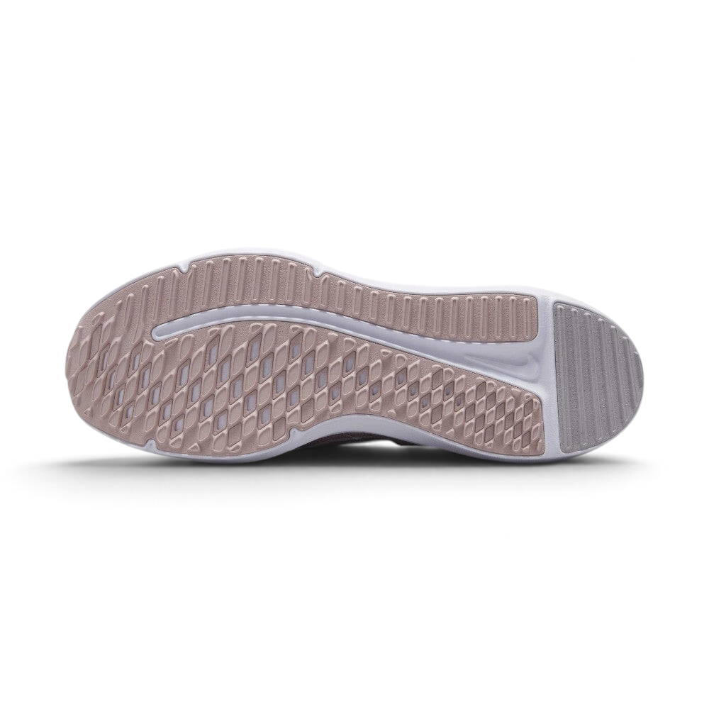 Displays the full-length rubber sole in pink and grey tones, featuring multi-directional flex grooves and a central white cavity exposing the foam cushioning core.