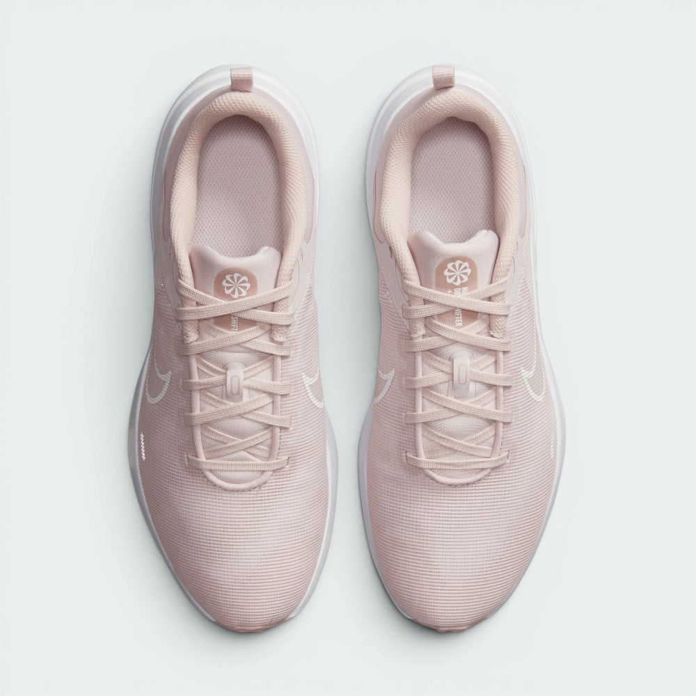 Focuses on the locked-in central lacing layout, displaying the clean symmetry of the pink mesh tongues, matching laces, circular Sunburst sustainability logos, and breathable forefoot mesh.