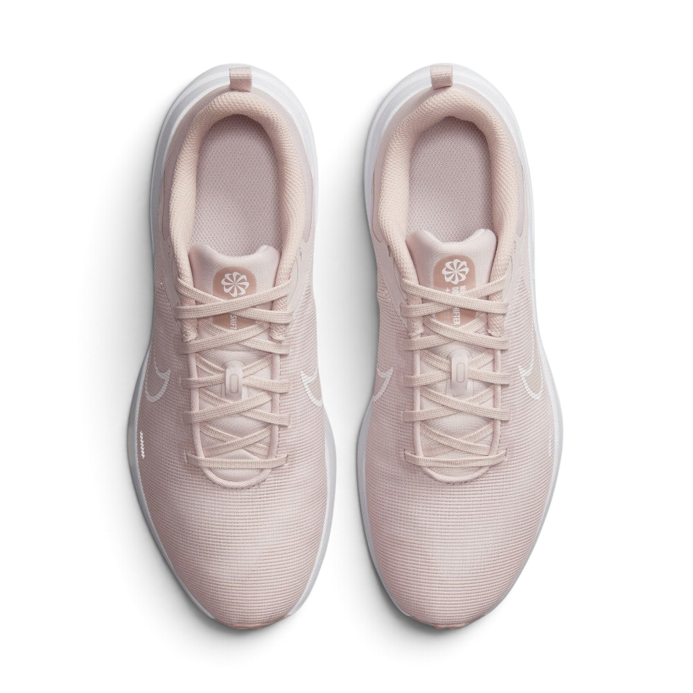 Focuses on the locked-in central lacing layout, displaying the clean symmetry of the pink mesh tongues, matching laces, circular Sunburst sustainability logos, and breathable forefoot mesh.