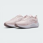Emphasising the low-cut, forward-leaning running stance of the trainers and the soft colour harmony between the Barely Rose uppers and clean white midsoles.