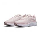 Emphasising the low-cut, forward-leaning running stance of the trainers and the soft colour harmony between the Barely Rose uppers and clean white midsoles.