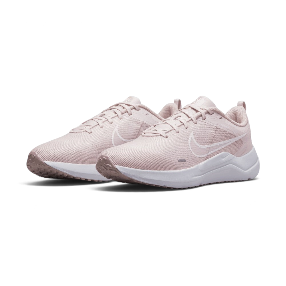 Emphasising the low-cut, forward-leaning running stance of the trainers and the soft colour harmony between the Barely Rose uppers and clean white midsoles.