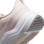 Highlights the "unreal" clean finish where the sculpted white foam midsole meets the Pink Oxford mesh heel counter, displaying the textured rubber tread pods and mini Swoosh accent below.