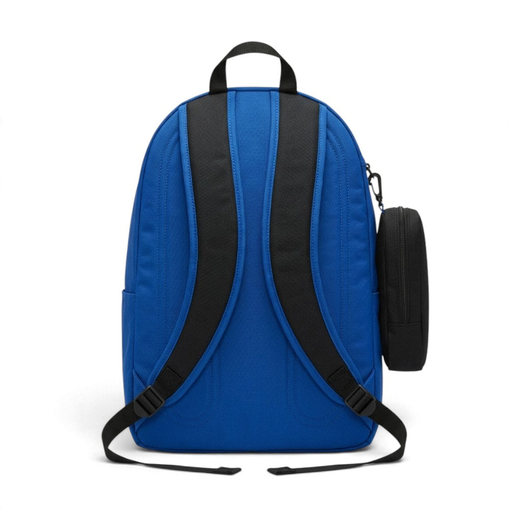 A royal blue backpack with black padded shoulder straps and a black side pouch attachment, shown from the back on a white background.
