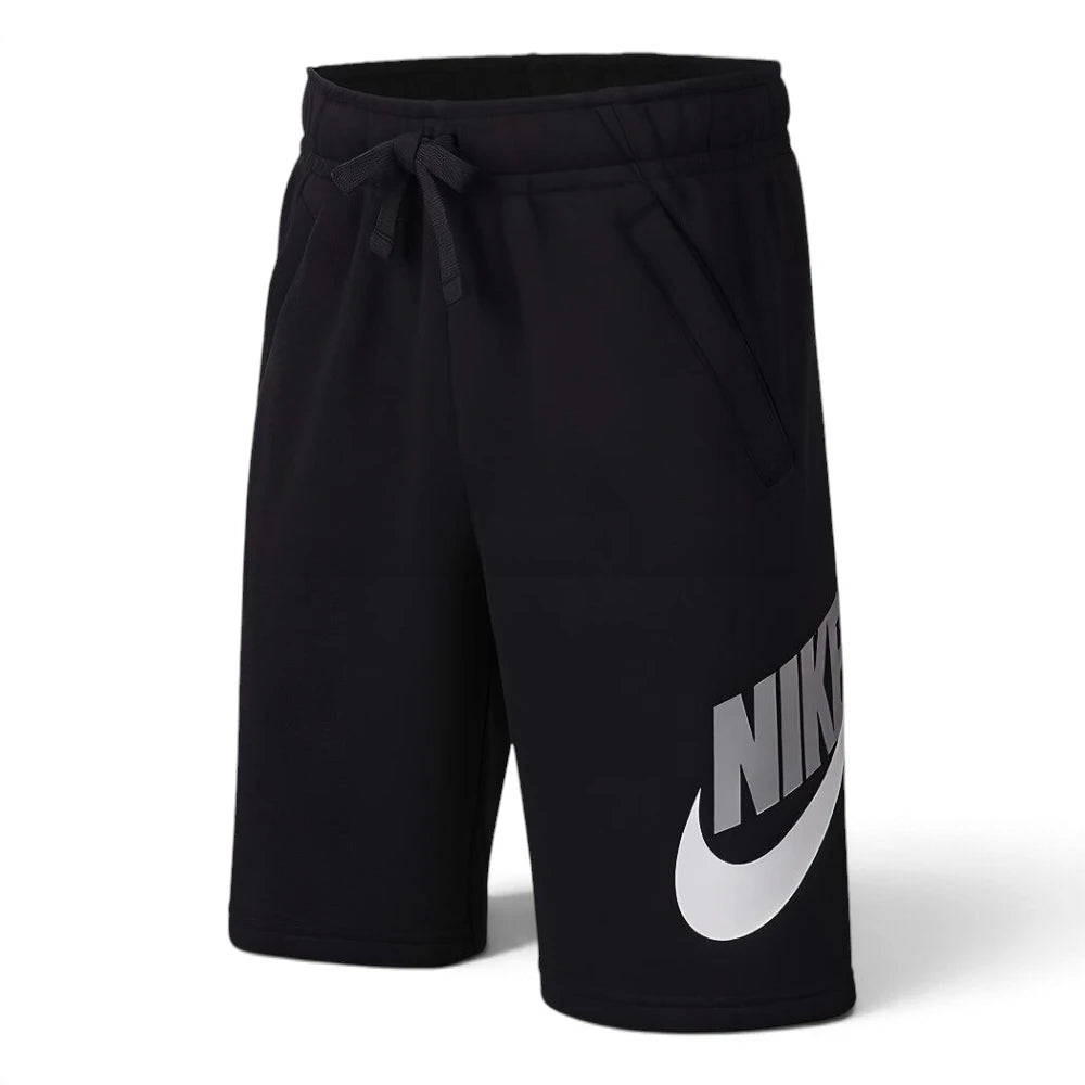 Studio product shot of the Nike Juniors Jersey Shorts in Black laid out on a ghost mannequin, showcasing the elasticated waistband, matching black drawcord, side pockets, and bold white Nike graphic on the left leg.

