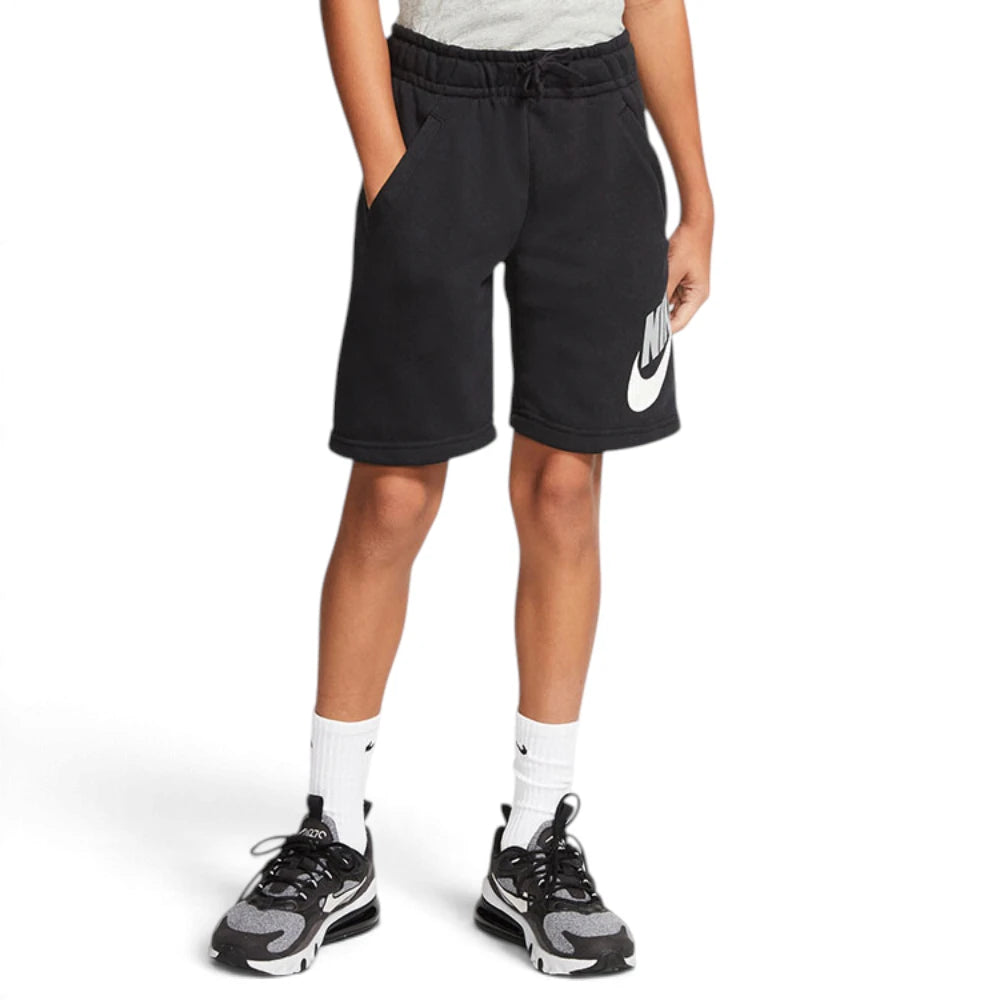 Full-body action pose of the young model wearing the complete outfit with black-and-grey trainers, illustrating daily wear styling and mobility.
