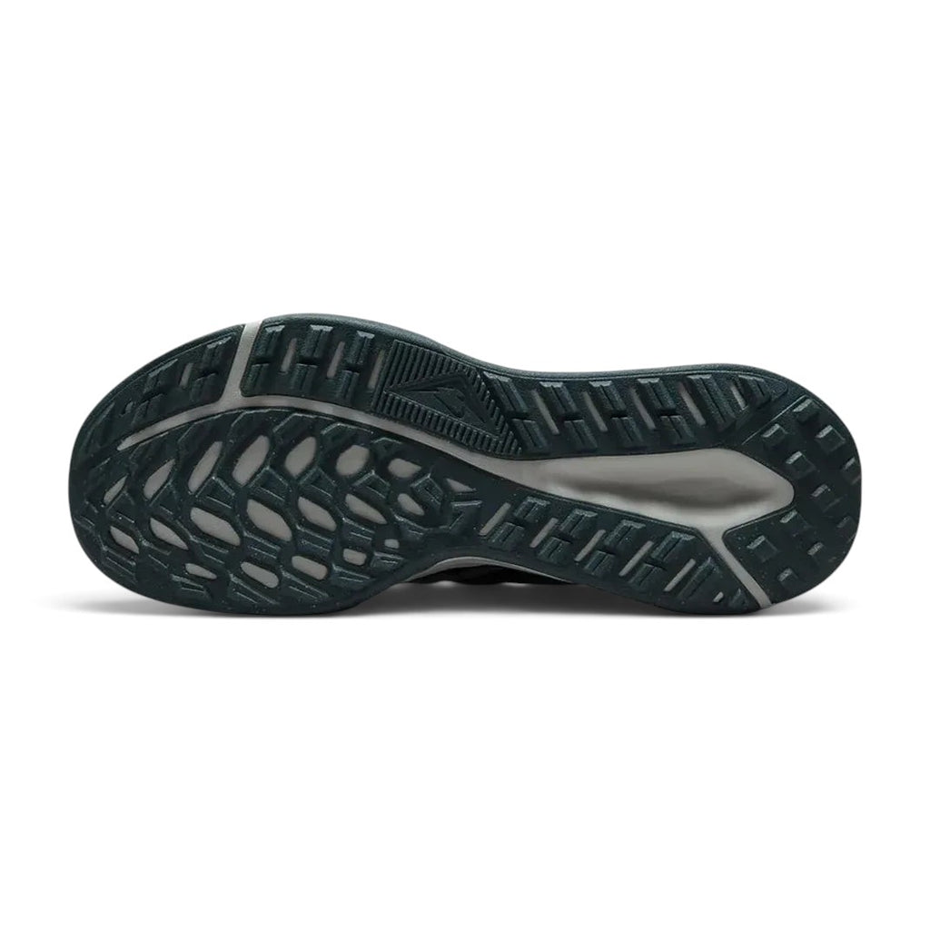 View of the outsole of the Nike Juniper Trail 2 Women's black trail shoes, showing deep, multi-directional rubber lugs for trail traction.