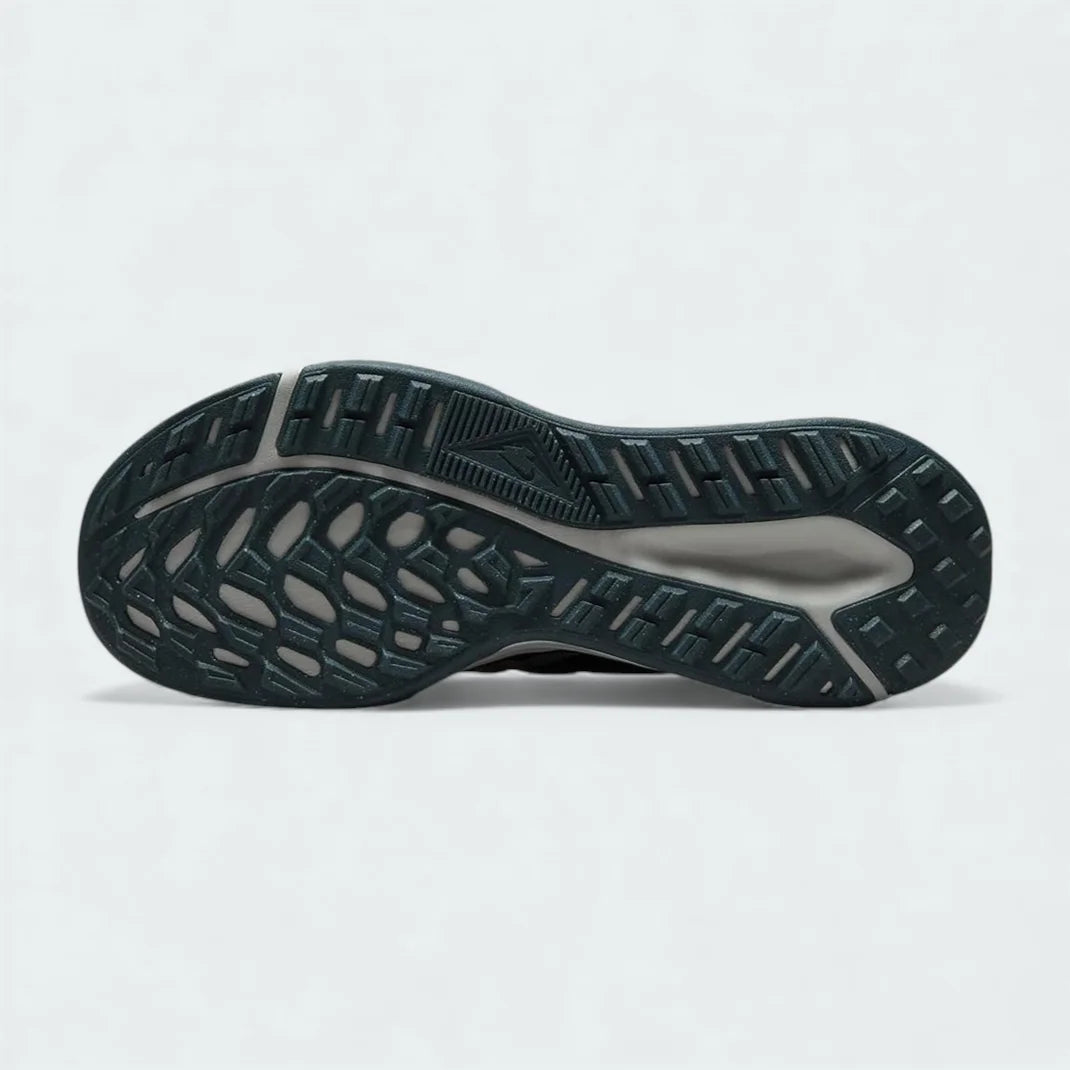 View of the outsole of the Nike Juniper Trail 2 Women's black trail shoes, showing deep, multi-directional rubber lugs for trail traction.