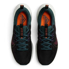 Top-down view of a pair of Nike Juniper Trail 2 Women's trail shoes in black, maroon, and green, highlighting their durable construction and lace-up closure.