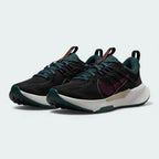 Angled view of two Nike Juniper Trail 2 Women's trail shoes in black and maroon, side by side, showcasing their robust design and athletic silhouette.