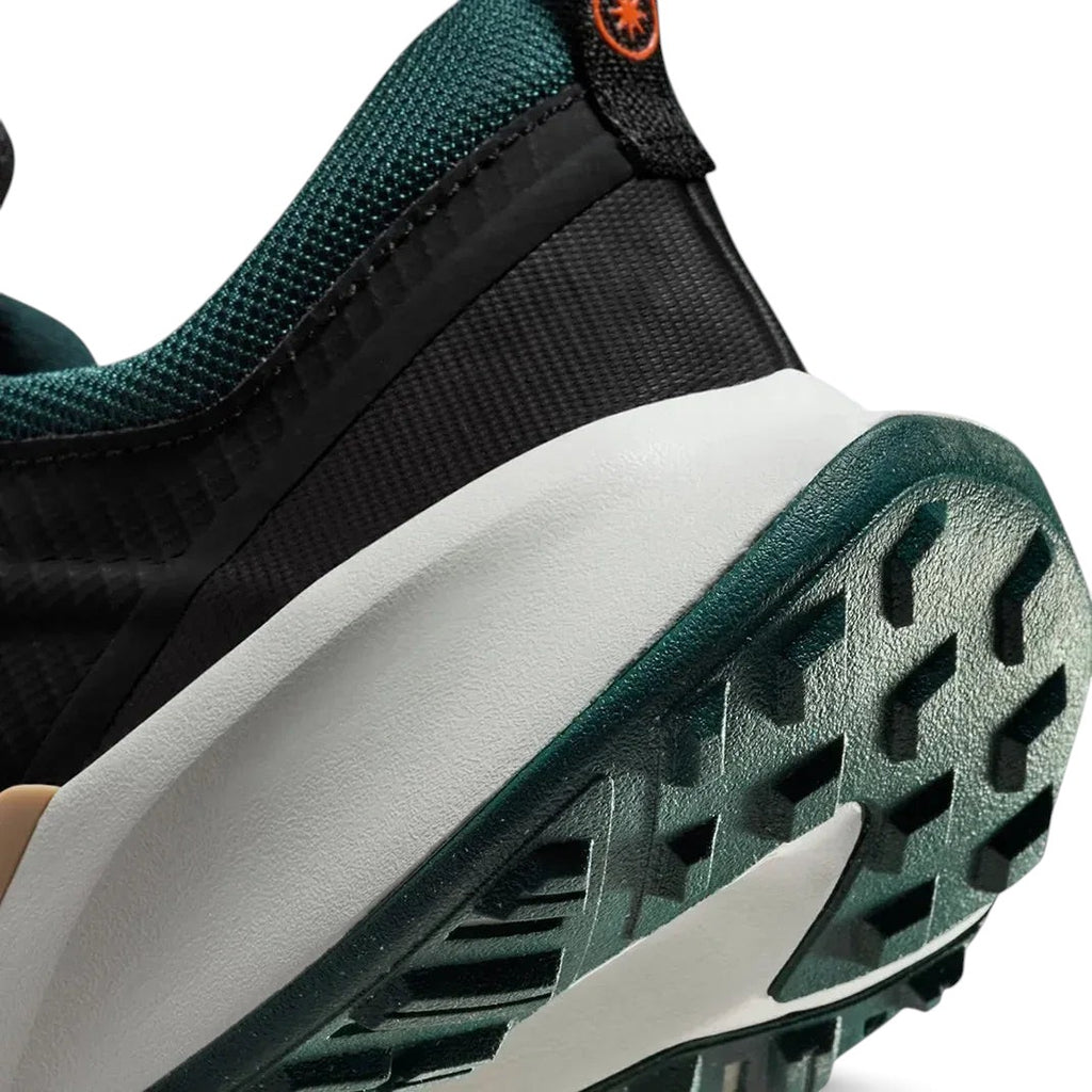 Detailed zoom on the outsole and midsole of the Nike Juniper Trail 2 Women's trail shoes, highlighting the cushioned foam and rugged rubber outsole.